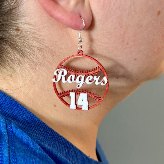 Personalized red and white baseball earring with Rogers and number 14 being worn.