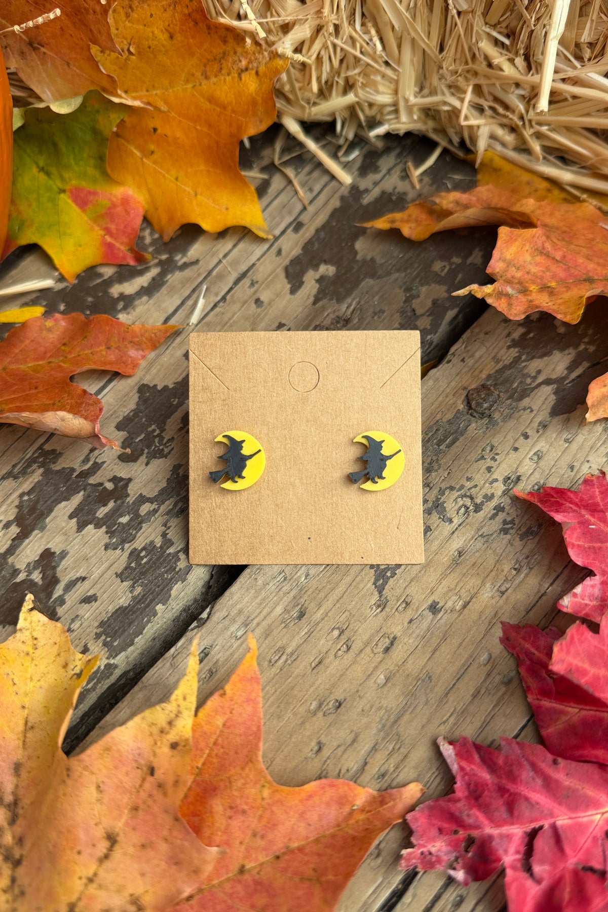 Flying witch moon Halloween stud earrings styled with fall leaves