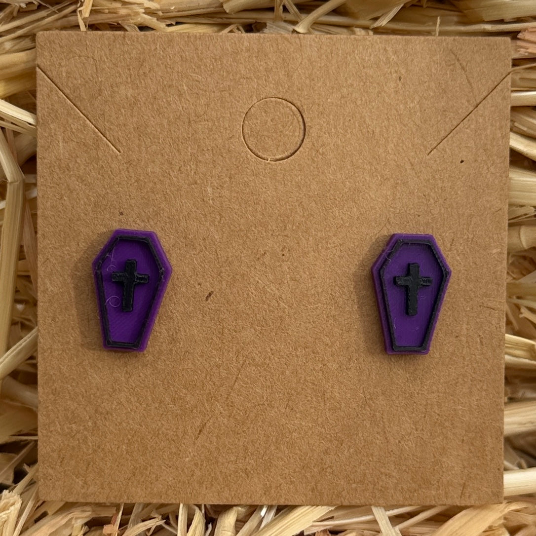 Purple coffin Halloween stud earrings on kraft card